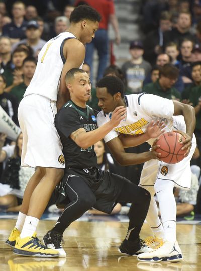 Hawai'i's Quincy Smith, center, gets caught in a screen between California's Ivan Rabb, left, and Roger Moute a Bidias, right, in their opening game in the NCAA Tournament Friday at the Spokane Arena. The University of Hawai'i beat the California Golden Bears, 77-66. (Jesse Tinsley / The Spokesman-Review)