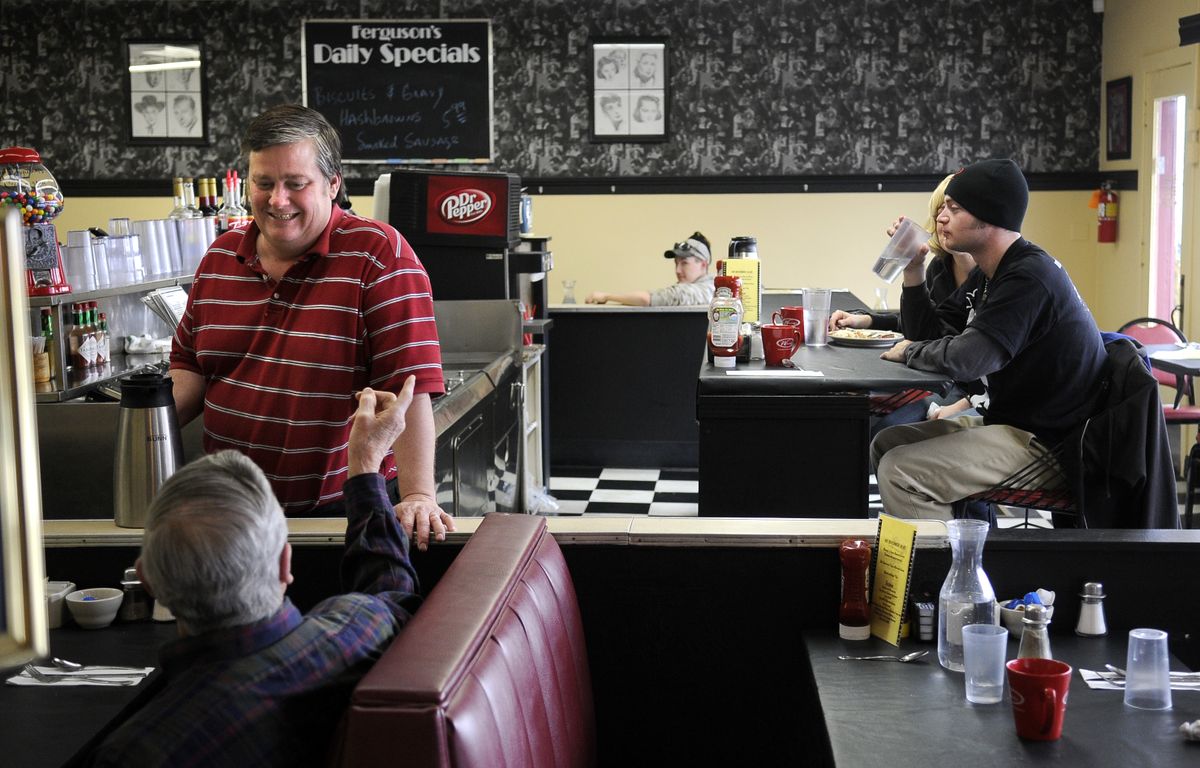 Jim Adolfson  waits on a customer at Ferguson’s Cafe recently. (Dan Pelle / The Spokesman-Review)