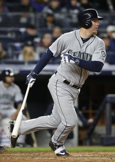 Seattle’s Adam Lind follows through on an RBI single during the sixth inning Friday. (Frank Franklin II / Associated Press)