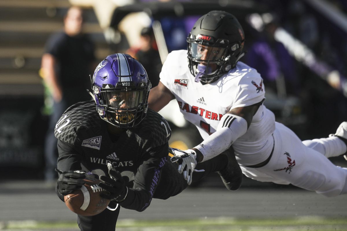 Weber State’s Rashid Shaheed  dives to catch a touchdown pass while defended by Eastern Washington’s Josh Lewis  during Saturday’s game  in Ogden, Utah. (Matt Herp / AP)