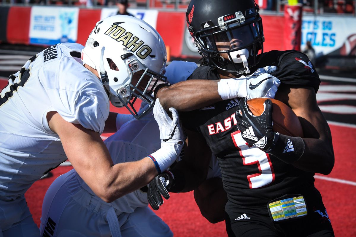 Eastern Washington University WR Nzuzi Webster (5) fights Idaho defenders Ty Graham, left, and Jalen Hoover, Saturday, Oct. 27, 2018, in Cheney, Wash. (Dan Pelle / The Spokesman-Review)