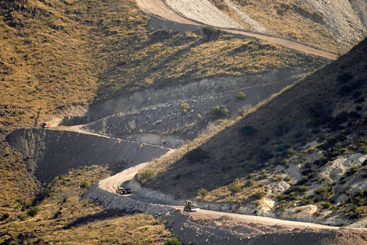 A pathway cleared by explosives to make way for border wall construction separates Mexico, right, and the USA on Wednesday in Guadalupe Canyon, Ariz.  (Matt York)