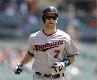 FILE - In this July 20, 2016, file photo, Minnesota Twins' Joe Mauer heads home after his solo home run during the first inning of a baseball game against the Detroit Tigers, in Detroit.  The Minnesota Twins will retire Joe Mauers No. 7 jersey next season, moving swiftly with the prestigious honor for the six-time All-Star who recently finished a 15-year major league career. The Twins surprised Mauer with the announcement while he was being celebrated at an all-student assembly at his alma mater Cretin-Derham Hall High School on Tuesday, Dec. 18, 2018.(AP Photo/Carlos Osorio, File) ORG XMIT: NY165 (Carlos Osorio / AP)