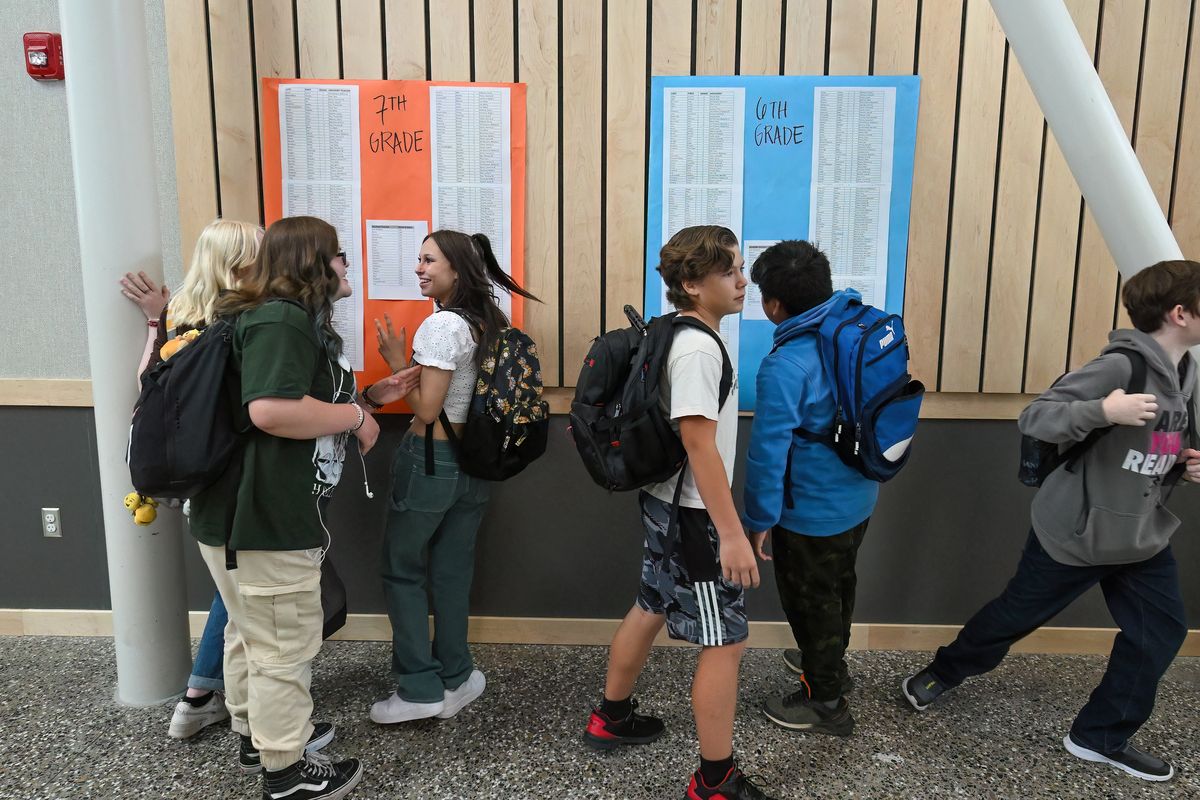 After entering their new school for the first time, Yasuhara Middle School students look for where their classrooms are located, Tuesday, September 6, 2022.  (COLIN MULVANY/THE SPOKESMAN-REVIEW)