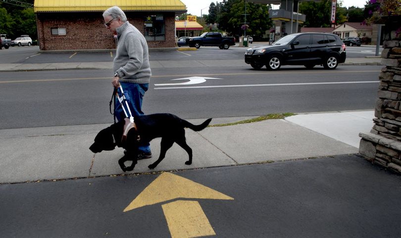 Carl Bessent walks with his guide dog Nerice through Coeur d'Alene recently. Carl is legally blind and is concerned about the growing problem of impostor or poorly trained service animals and the problems they create for legitimate service animals. (Kathy Plonka / Spokesman-Review)