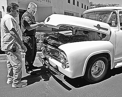 CHP officer Greg Bennett and Harold Voelker, of southern California, get a look at Voelker's 1956 Ford F-100 truck that was stolen from him in 1972.  (Associated Press)