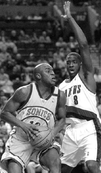 
Seattle's Damien Wilkins is defended by Martell Webster.
 (Associated Press / The Spokesman-Review)