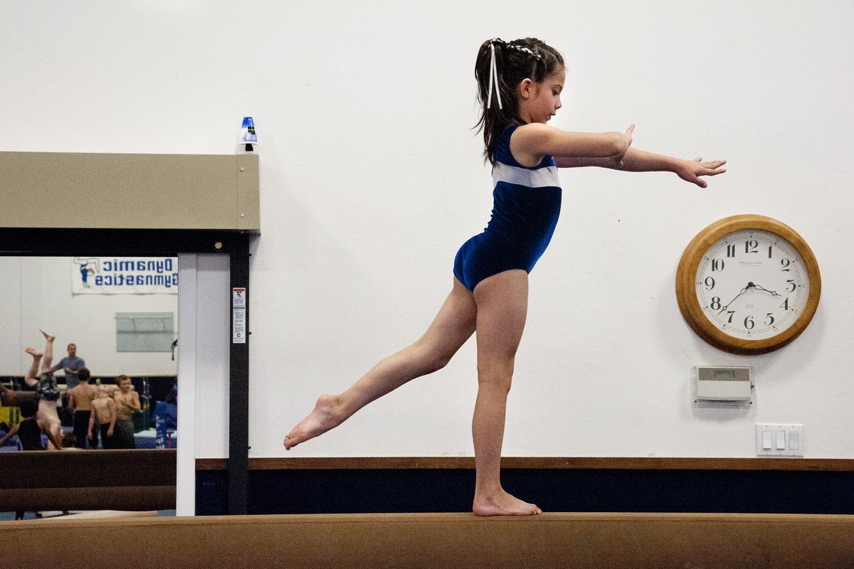 Trinity Tanner, 8, works on her balance beam routine Aug. 6, at Dynamic Gymnastics in north Spokane. (Dan Pelle)