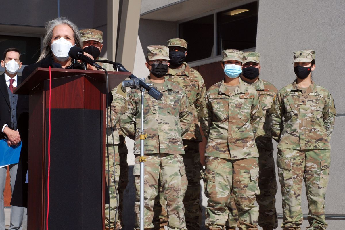 FILE — New Mexico Gov. Michelle Lujan Grisham, left, announced efforts to temporarily employ National Guard troops and state bureaucrats as substitute teachers and preschool caregivers, during a news conference, at Sante Fe High School, in Santa Fe, N.M., Jan. 19, 2022. Schools that may have first turned to librarians, custodians and support staff to step into empty classes have had to look beyond their buildings in recent weeks as exposures, illness and quarantines keep teachers at home for days at a time. (Morgan Lee)