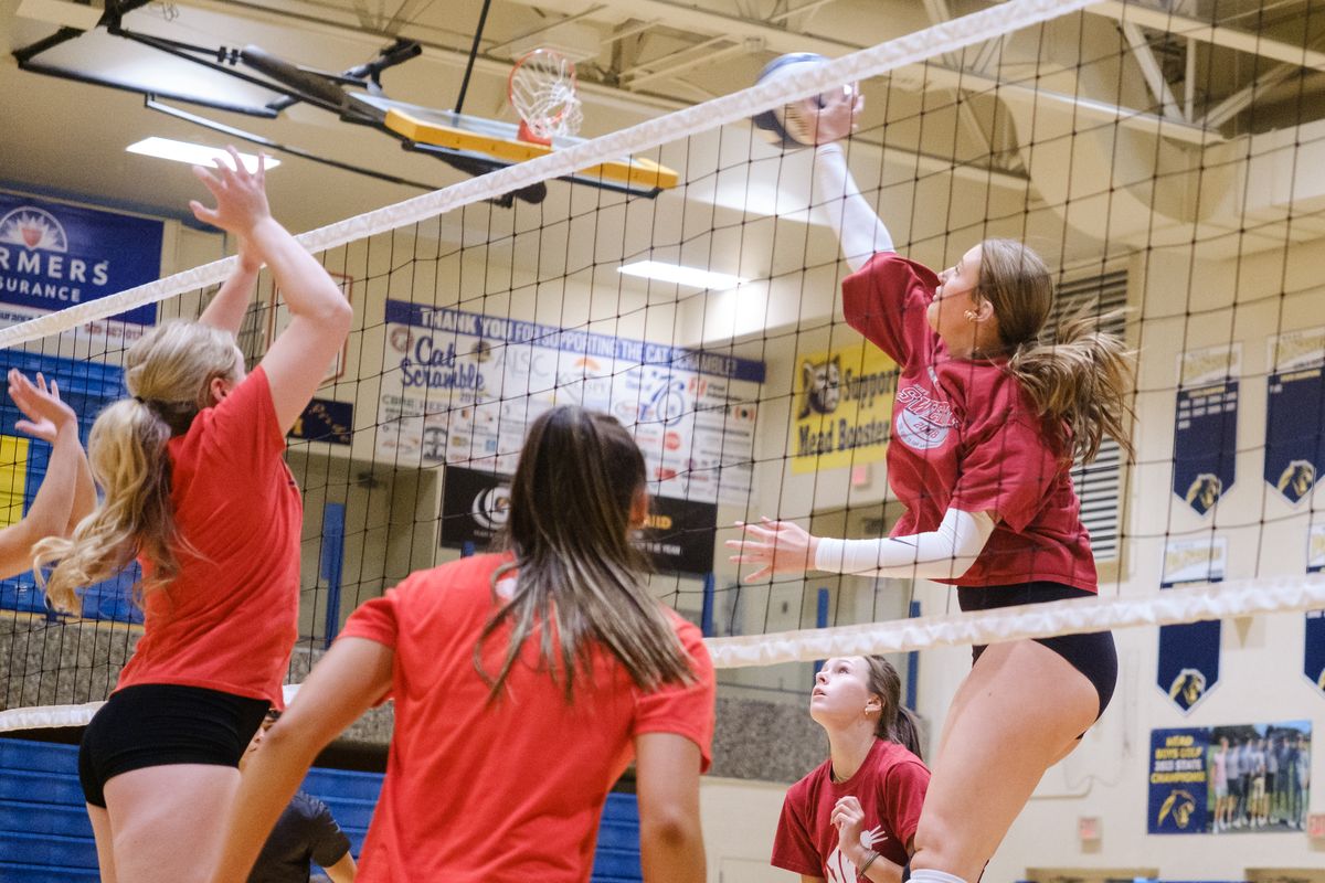 Mead middle hitter Ava Durgan, right, goes up for a kill during a practice on Wednesday, Sept. 4, 2024, at Mead High School in Spokane, Washington.  (Madison McCord/The Spokesman-Review)