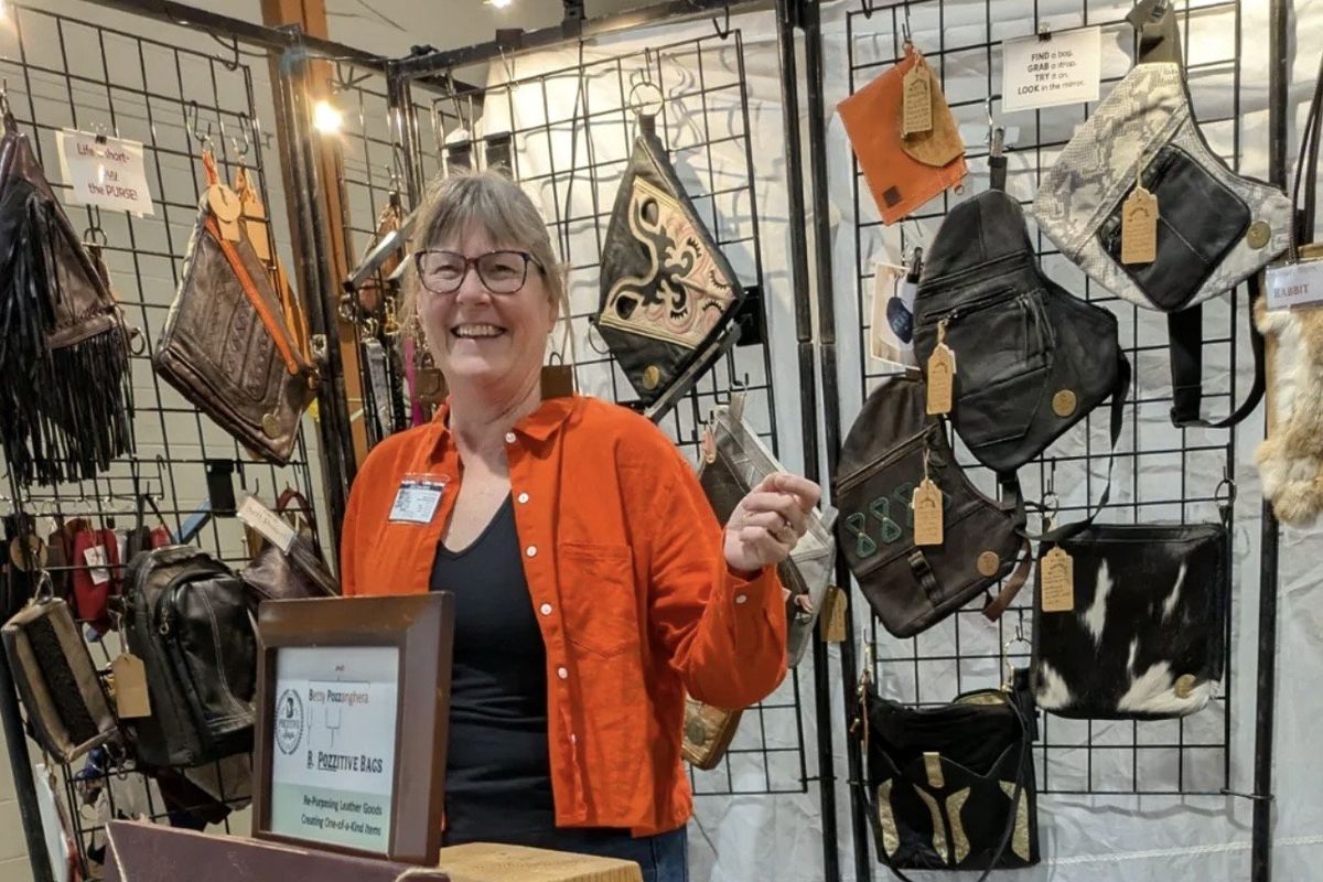 Betsy Pozzanghera with her repurposed leather handbags last March at the Custer’s Spring Arts and Crafts Show in Spokane.  (Courtesy of Barbara J. Wilson)