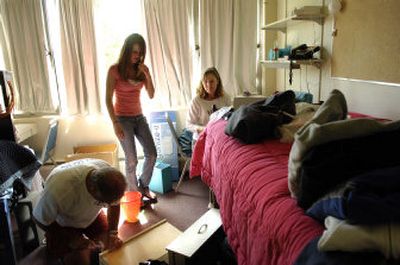 
Gonzaga University freshman Sarah Rotar, center, of Missoula, arranges her residence hall room with help from her parents, Mark and Wanda, on Friday afternoon. Students are flooding back to Spokane after the summer break. 
 (Holly Pickett / The Spokesman-Review)