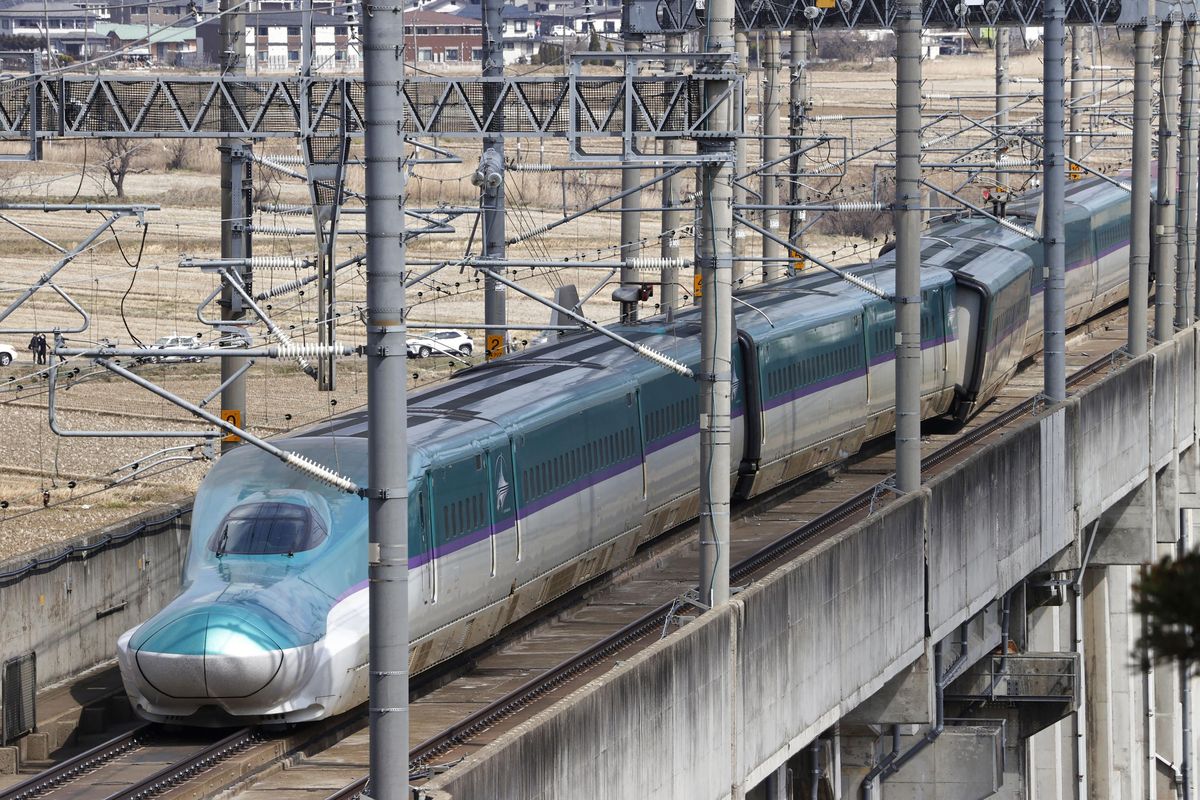 A partially derailed express train sits following an earthquake in Shiroishi, Miyagi prefecture, northern Japan Thursday, March 17, 2022. A powerful earthquake struck off the coast of Fukushima in northern Japan on Wednesday night, smashing furniture, knocking out power and killing some people. A small tsunami reached shore, but the low-risk advisory was lifted by Thursday morning.  (SUB)