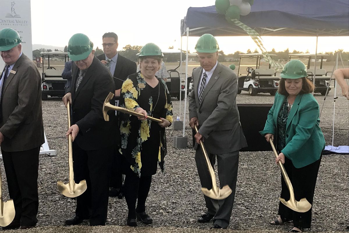 Officials toss symbolic shovels of dirt during a groundbreaking ceremony Thursday, Aug. 29, 2019, for the new Ridgeline High School in Liberty Lake. Holding the golden shovels, from left, are Central Valley School District board member Keith Clark, Sen. Mike Padden, board member Debbie Long, Liberty Lake Mayor Steve Peterson and board member Mysti Reneau. CVSD Superintendent Ben Small looks on from the background. (Nina Culver / The Spokesman-Review)