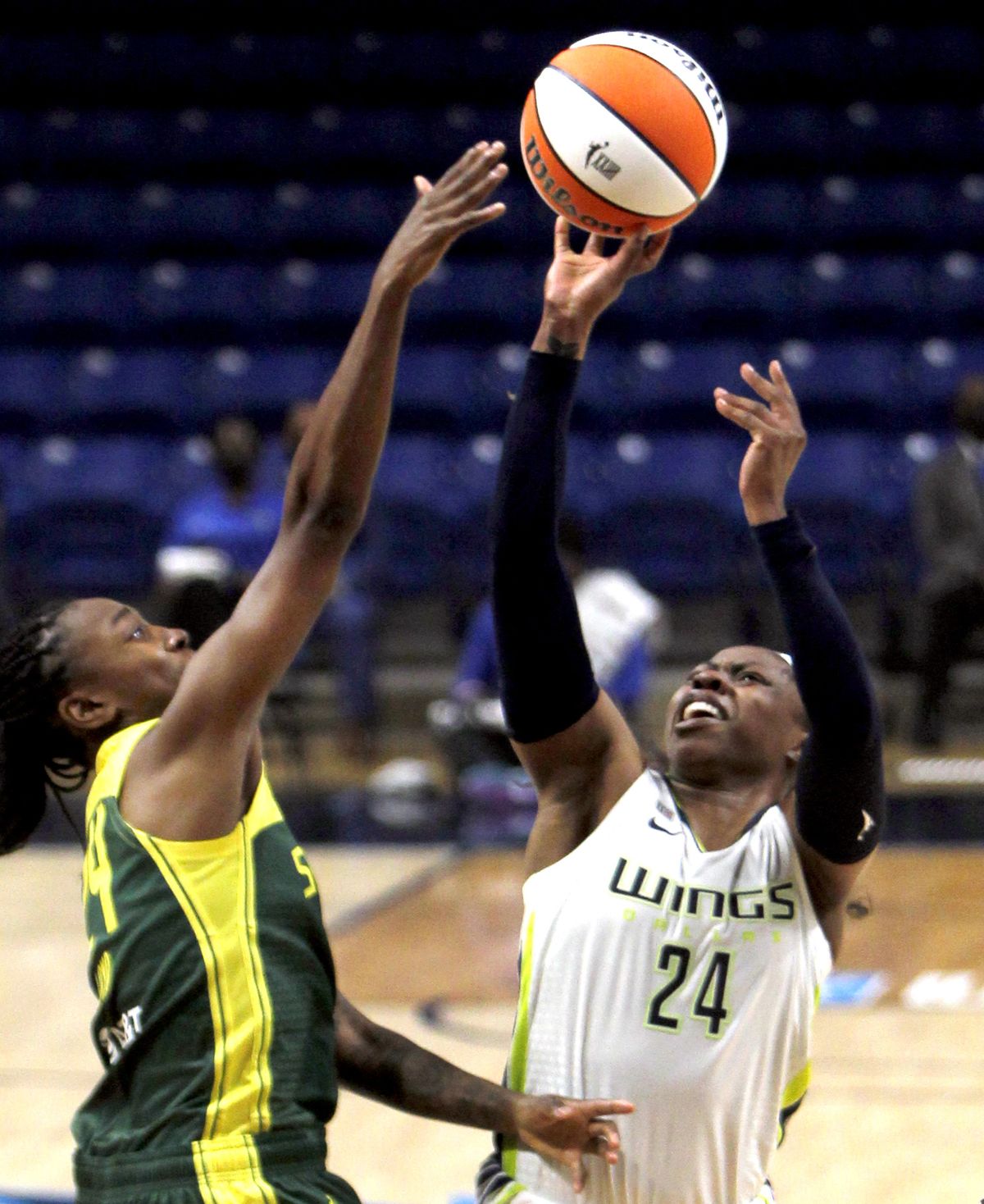 Dallas Wings guard Arike Ogunbowale (24) shoots against Seattle Storm guard Jewell Loyd, left, during the first half of a WNBA basketball game Saturday, May 22, 2021, in Arlington, Texas. (Associated Press)