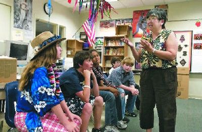 
During a luau with her Centennial l sixth-graders Ruth Conklin explains why Hawaiians eat Spam. 
 (J. BART RAYNIAK / The Spokesman-Review)