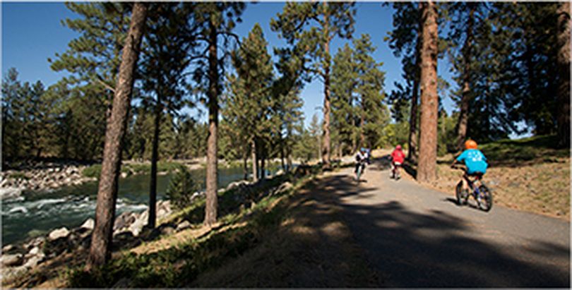 Cyclists pedal along the Spokane River Centennial Trail in Spokane.