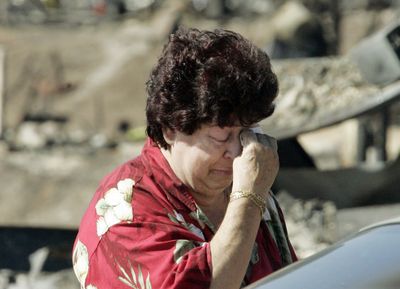 Faith Schwartz sobs outside the ruins of her home  in the Sylmar area of Los Angeles on Tuesday.  (Associated Press / The Spokesman-Review)