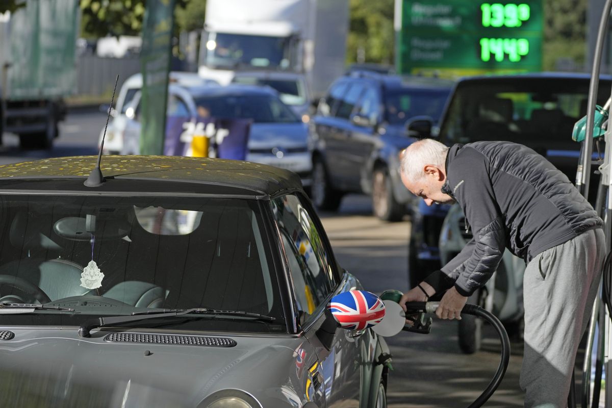 A man fills his car at a petrol station in London, Wednesday, Sept. 29, 2021. Prime Minister Boris Johnson sought to reassure the British public Tuesday that a fuel-supply crisis snarling the country was “stabilizing,” though his government said it would be a while before the situation returns to normal. Johnson