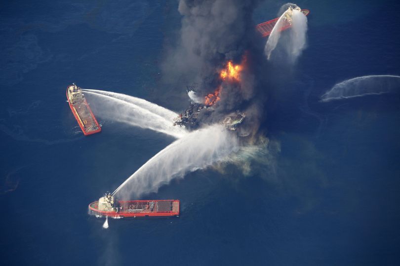 In this Wednesday, April 21, 2010 aerial file photo taken in the Gulf of Mexico, more than 50 miles southeast of Venice on Louisiana's tip, the Deepwater Horizon oil rig is seen burning. The oil platform that burned for 36 hours after a massive explosion sank into the Gulf of Mexico on Thursday, April 22, 2010, the U.S. Coast Guard said. (Gerald Herbert / Associated Press)