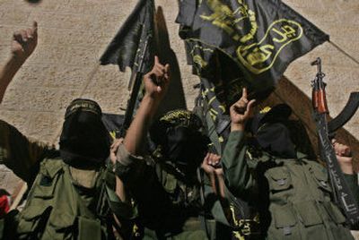 
Palestinian masked gunmen of the Islamic Jihad gesture during a press conference in the Khan Younis refugee camp, in the southern Gaza Strip, late Sunday. An Islamic Jihad official claimed responsibility for a suicide bombing that took place Sunday morning, but no official announcement was made. 
 (Associated Press / The Spokesman-Review)