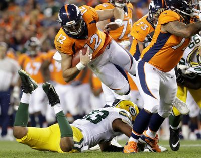 Denver Broncos quarterback Paxton Lynch (12) is upended by Green Bay Packers linebacker Reggie Gilbert (93) during Saturday’s preseason game. (Joe Mahoney / Associated Press)