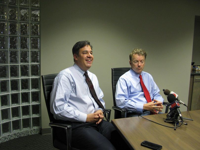 Idaho Rep. Raul Labrador, left, with Kentucky Sen. Rand Paul, right, tells reporters in Boise on Friday that he's running for House majority leader (Betsy Russell)