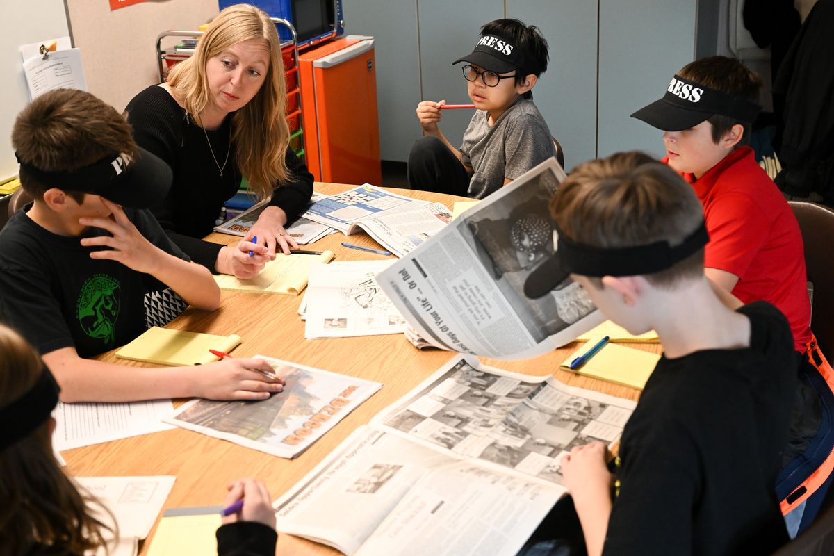 Clockwise from left: Fifth-grader Noah Schott speaks with teacher Heidi Keiper about ideas for Evergreen Elementary’s upcoming student newspaper as Ray Kashtok, Edsel Siira, Ryder Thomspon and Rebecca Cramer listen and also offer ideas on Dec. 11 at the school in north Spokane.  (Tyler Tjomsland/The Spokesman-Review)