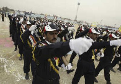 
Iraqi police march in formation during a ceremony Thursday marking one year since Iraqi security forces took control of Najaf, 100 miles south of Baghdad. 
 (Associated Press / The Spokesman-Review)