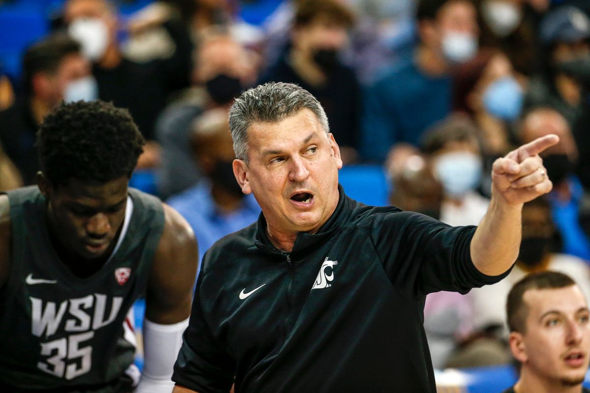 Washington State coach Kyle Smith confers with post Mouhamed Gueye during a Pac-12 game against UCLA on Feb. 17 in Los Angeles.  (Associated Press)