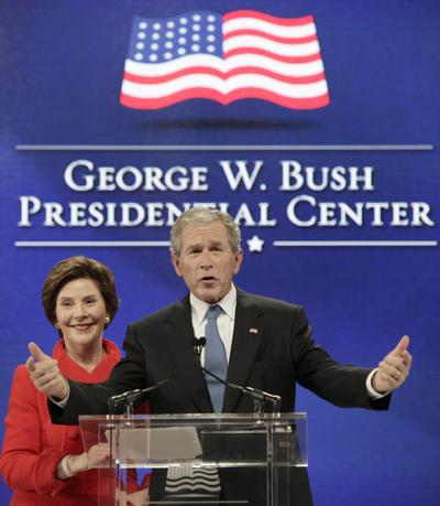 Former President George W. Bush, right, speaks with his wife, Laura, by his side during the groundbreaking for his presidential library  Tuesday.  (Associated Press)