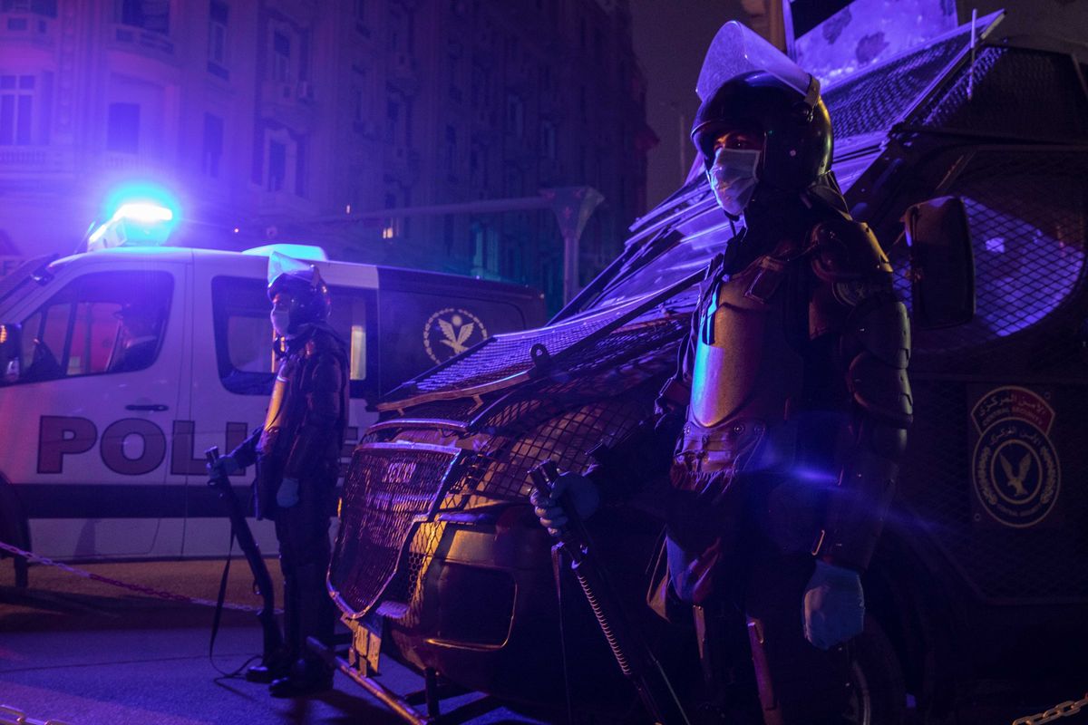 FILE - In this March 29, 2020 file photo, Egyptian security forces cordon off roads during curfew hours as prevention measures due to the coronavirus outbreak, in Cairo, Egypt. Coronavirus infections are surging in the country of 100 million, threatening to overwhelm Egyptian hospitals. Egypt has the highest death toll in the Arab world. Yet even as authorities fight the swelling outbreak, they have also tried to stifle nearly all criticism about the government’s handling of the health crisis.  (Nariman El-Mofty)