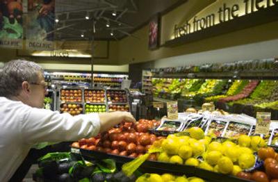 
Tony Domer  arranges produce in the newly remodeled Safeway store at 14020 E. Sprague Ave. The store will host an open house Friday. 
 (Holly Pickett / The Spokesman-Review)