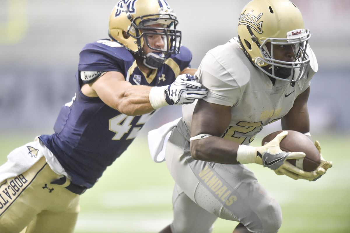 Idaho running back Aaron Duckworth eludes Montana State’s Mac Bignell back on Sept. 1 at the Kibbie Dome in Moscow, Idaho. (Tyler Tjomsland / The Spokesman-Review)