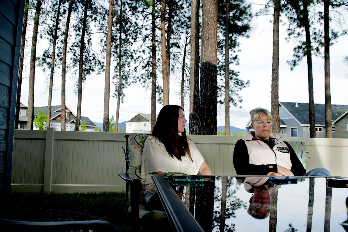 Greg Moore’s wife, Lindy Moore, left, meets with his ex-wife, Jennifer Brumley, at Moore’s home in Coeur d’Alene on Thursday. (Kathy Plonka)