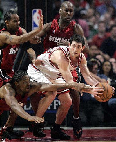 
Chicago's Kirk Hinrich, center, looks to pass around three Miami defenders in the Bulls' 93-87 victory over the Heat. 
 (Associated Press / The Spokesman-Review)