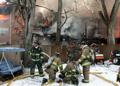 
Firefighters walk through debris from an explosion that tore through a three-story apartment building and killed three people Tuesday in Bergenfield, N.J.
 (Associated Press / The Spokesman-Review)