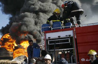 
Firefighters attempt to extinguish a fire at an  oil refinery Monday in the Dora neighborhood of  Baghdad. Associated Press
 (Associated Press / The Spokesman-Review)