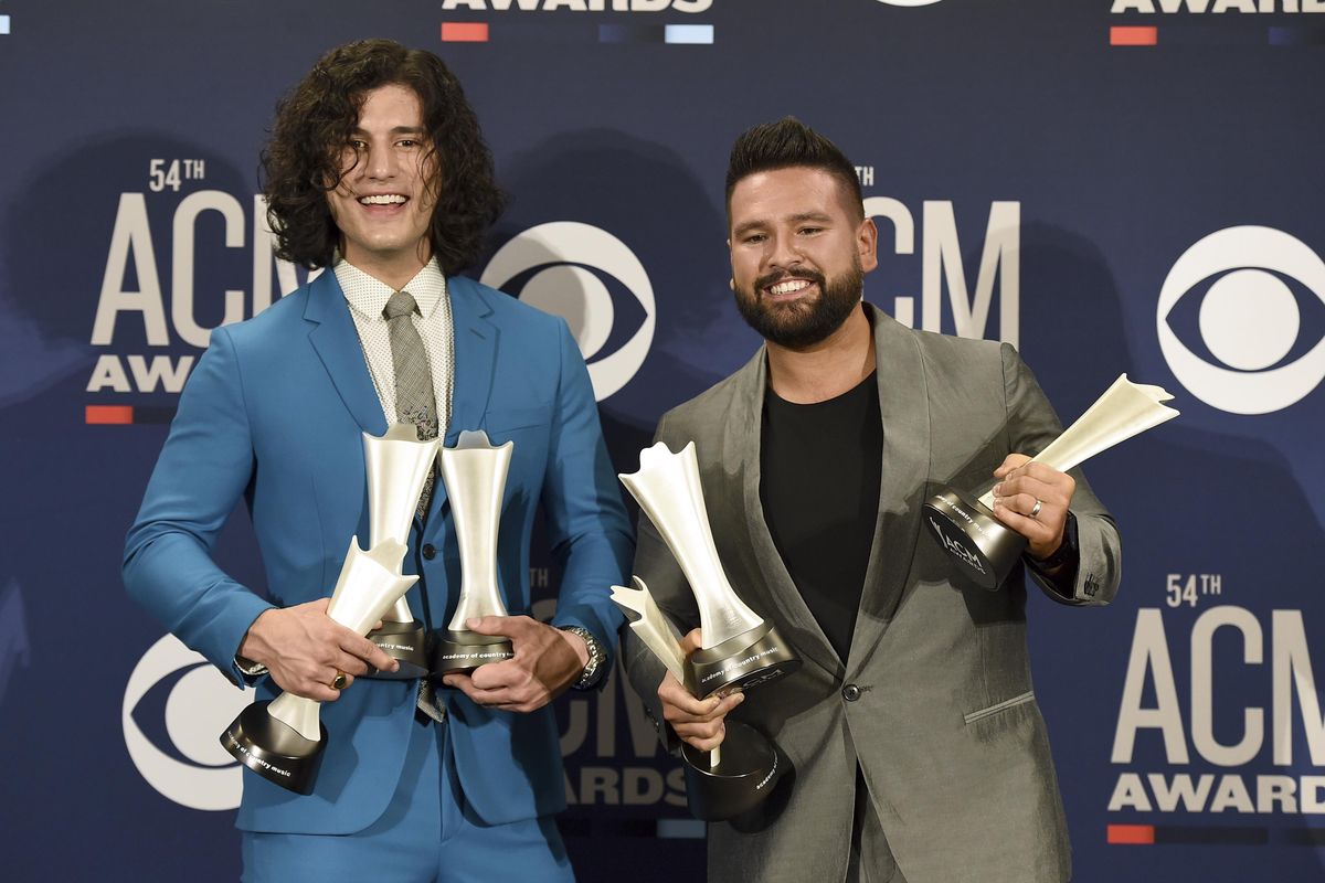 Dan Smyers, left, and Shay Mooney, of Dan + Shay, pose in the press room with the awards for song of the year and single of the year for “Tequila,” and duo of the year at the 54th annual Academy of Country Music Awards on April 7 in Las Vegas. (Jordan Strauss / Jordan Strauss/Invision/AP)