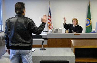 
Court Commissioner Virginia Rockwood swears in Drew Backlund to Municipal Court on Wednesday in Spokane before hearing his case concerning a traffic infraction. 
 (Dan Pelle / The Spokesman-Review)