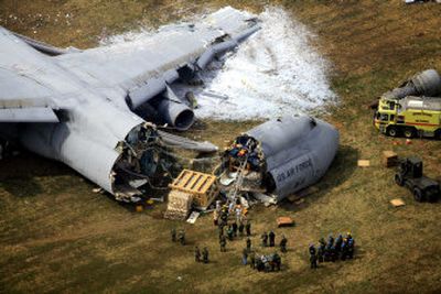 
Emergency crews respond to a C-5B cargo plane that crashed Monday at Dover Air Force Base in Dover, Del. 
 (Associated Press / The Spokesman-Review)