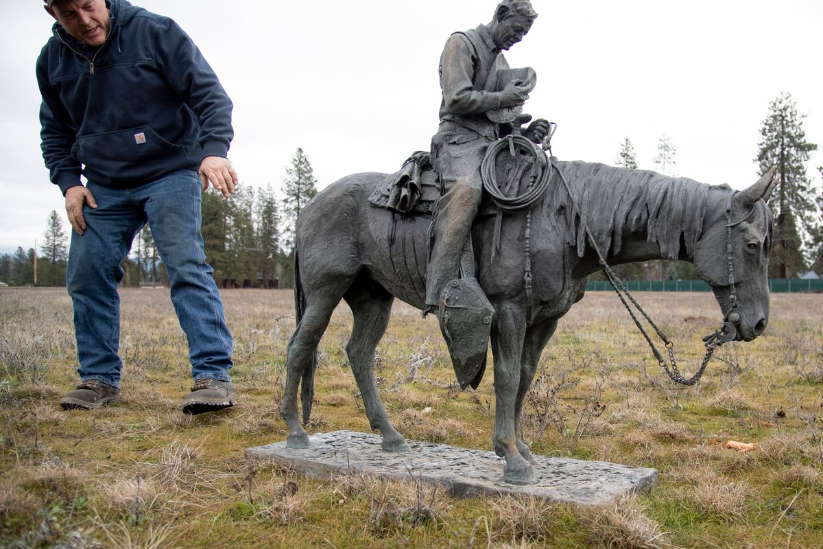 Matt Copenhaver looks over a bronze statue, sculpted by his sister Deborah Copenhaver-Fellows as a tribute to their father, Deb Copenhaver, a rodeo rider and World War II veteran who died in 2019. The statue was stolen from a roadside chapel in Creston, Washington which was built by Deb Copenhaver. The bronze was ripped off its pedestal around Dec. 1.  (Jesse Tinsley/THE SPOKESMAN-REVIEW)