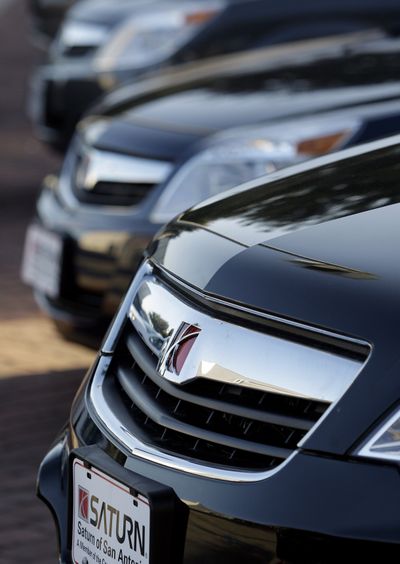 Saturn automobiles sit at a lot in San Antonio. General Motors Co. is giving dealers financial incentives to move Saturns and Pontiacs off their lots. The brands are being discontinued and GM wants dealers to get rid of their leftover inventories.  (FILE Associated Press)