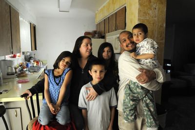 The Romero family – from left, Isabel, 7; Jennifer; little Marco, 9; Helina, 12; Marco; and Mateo, 4 –  pose Thursday in the house they recently bought in Post Falls.  (Jesse Tinsley / The Spokesman-Review)