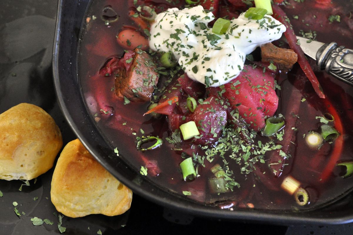 Iryna Grayson serves borscht with a dollop of sour cream, chopped green onions and a sprinkling of parsley. (Adriana Janovich)
