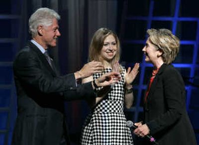 
Former President Bill Clinton moves to embrace his wife, Sen. Hillary Rodham Clinton,  as their daughter, Chelsea Clinton, looks on Thursday in New York. Associated Press
 (Associated Press / The Spokesman-Review)