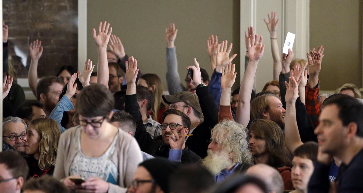 Hands are raised during a vote at a Democratic caucus in Seattle on March 26, 2016. The Washington state Democrats are holding their convention Friday through Sunday, June 17-19, 2016.
Elaine Thompson (Elaine Thompson / Associated Press)