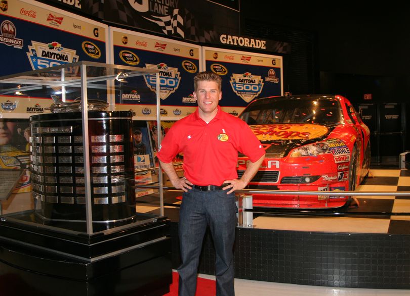 2010 Daytona 500 Champion Jamie McMurray stands in between the Harley J. Earl Trophy and his winning No. 1 Bass Pro Shops Chevrolet, which was inducted into the Daytona 500 Experience Monday in Daytona Beach, Fla. (Photo courtesy of NASCAR)