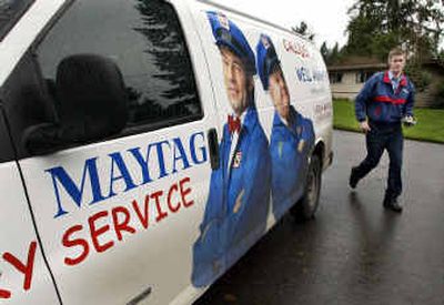 
Paul Adams, a Maytag repairman who was recruited by the company after he served four years in the Army, carries a part as he walks around his van last week, while making a service call in Bellevue, Wash. Former soldiers returning from Iraq or Afghanistan are finding that their military background has value at Maytag Corp., which has an aggressive recruiting program turning recently discharged soldiers into repair technicians.
 (Associated Press / The Spokesman-Review)