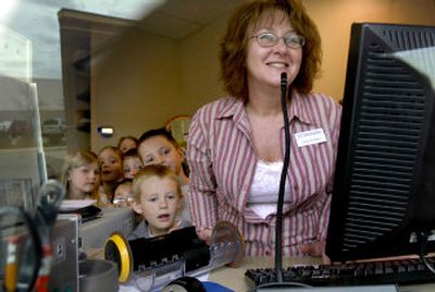 Numerica Credit Union teller Leslie Carlson had an audience of second-graders from Bryan Elementary at the bank's Coeur d'Alene branch office.
(Kathy Plonka / The Spokesman-Review)